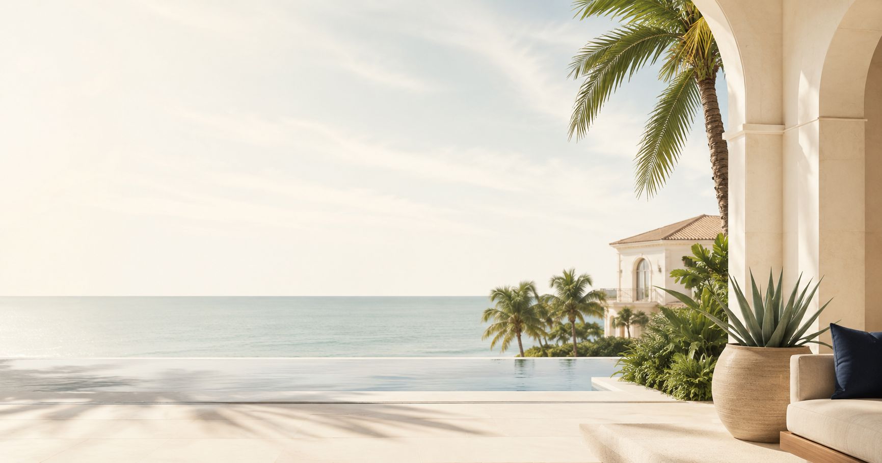 Oceanfront Palm Beach County terrace with an infinity pool and palms overlooking the Atlantic